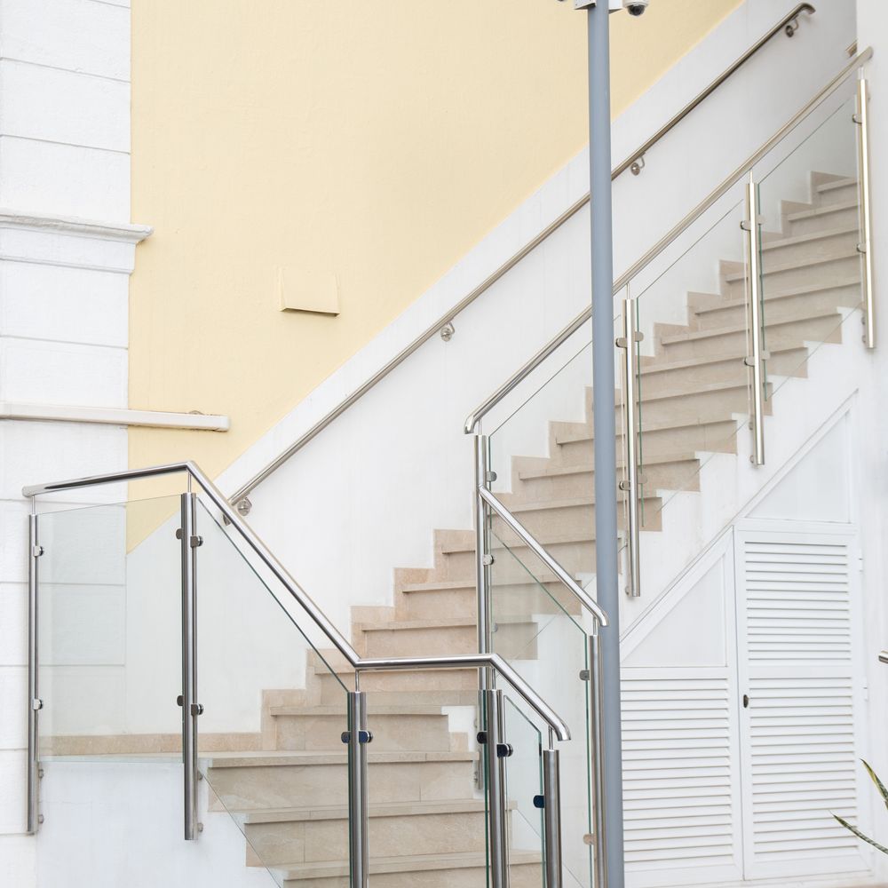 Glass stair railing with stainless steel posts and handrail