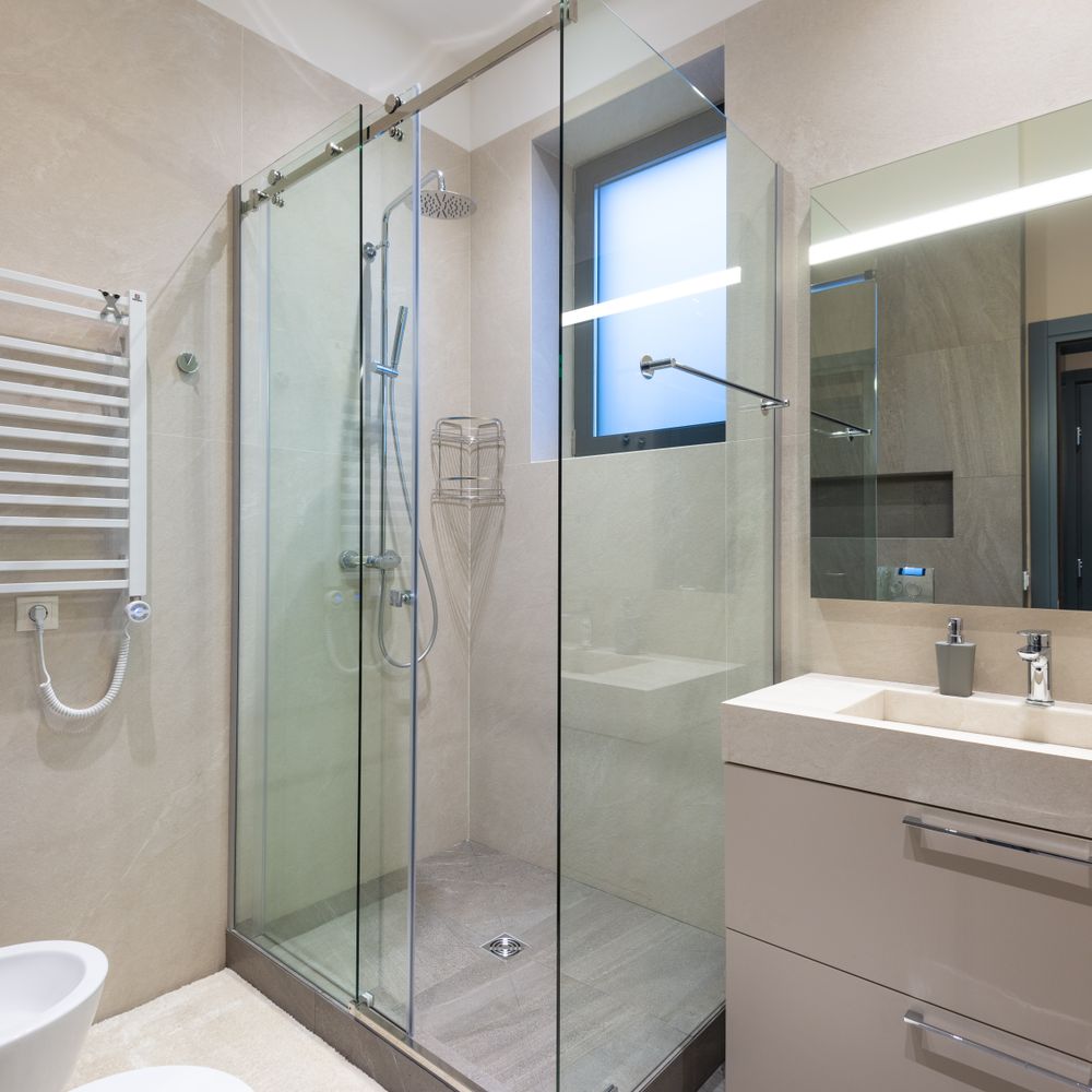 Frameless sliding glass shower enclosure in a modern bathroom